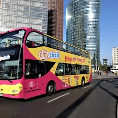 City Circle Berlin Bus, standing at Postdamer Platz, blue sky, skyscrapers in the background