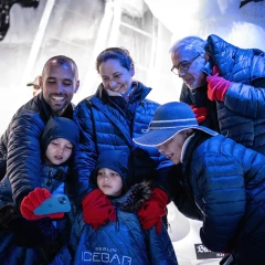 Icebar Berlin, group stands with thick jackets, gloves in the icebar, in the background you can see the ice sculptures