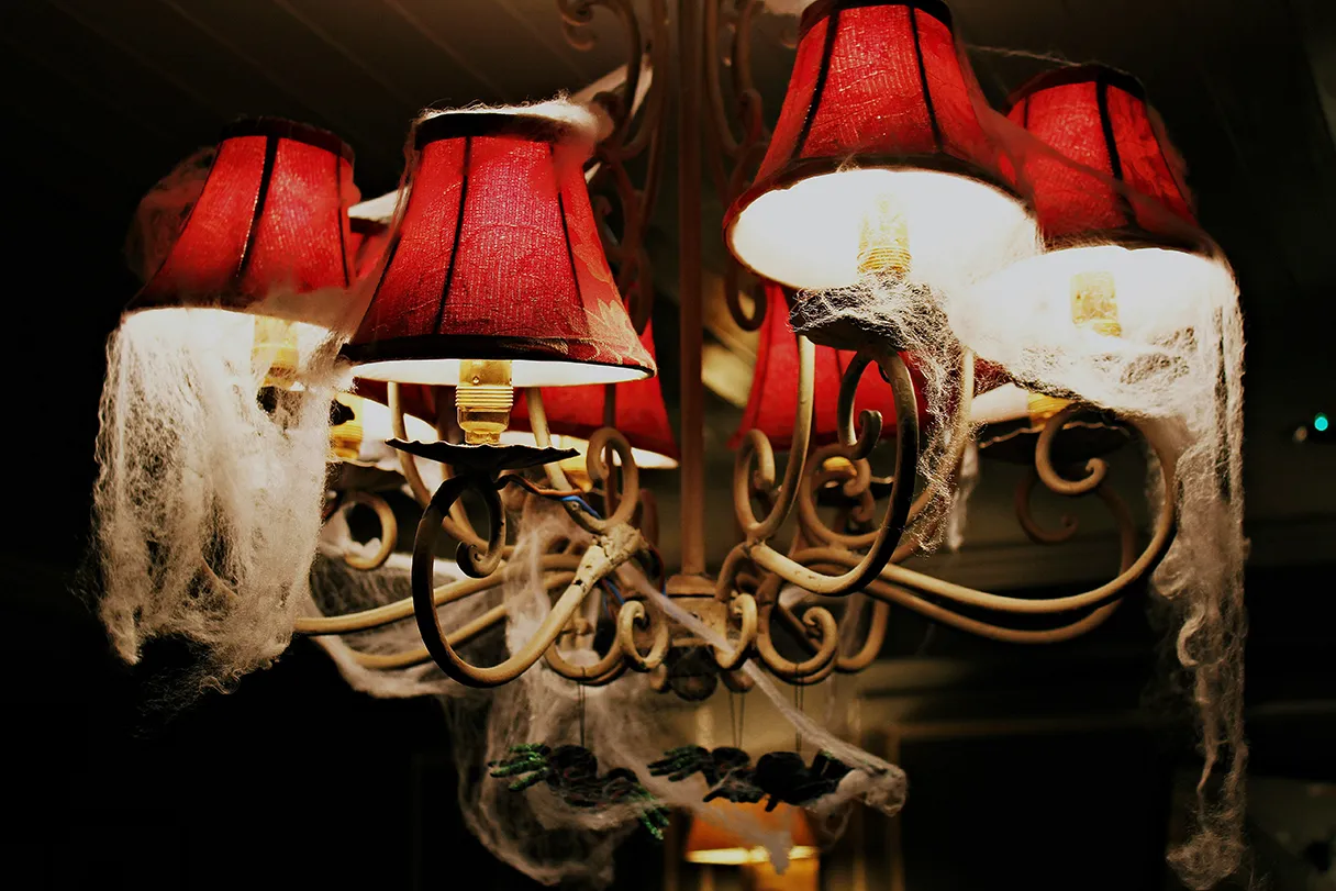 Halloween, ceiling lamp with red shade and lots of spider webs