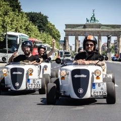 Hotrod Tour Berlin, motorized soapbox ride on the 17th of June in Berlin, in the background is the Brandenburg Gate