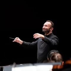 Biennale of the Berliner Philharmoniker. Petrenko stands at the podium and conducts his orchestra.