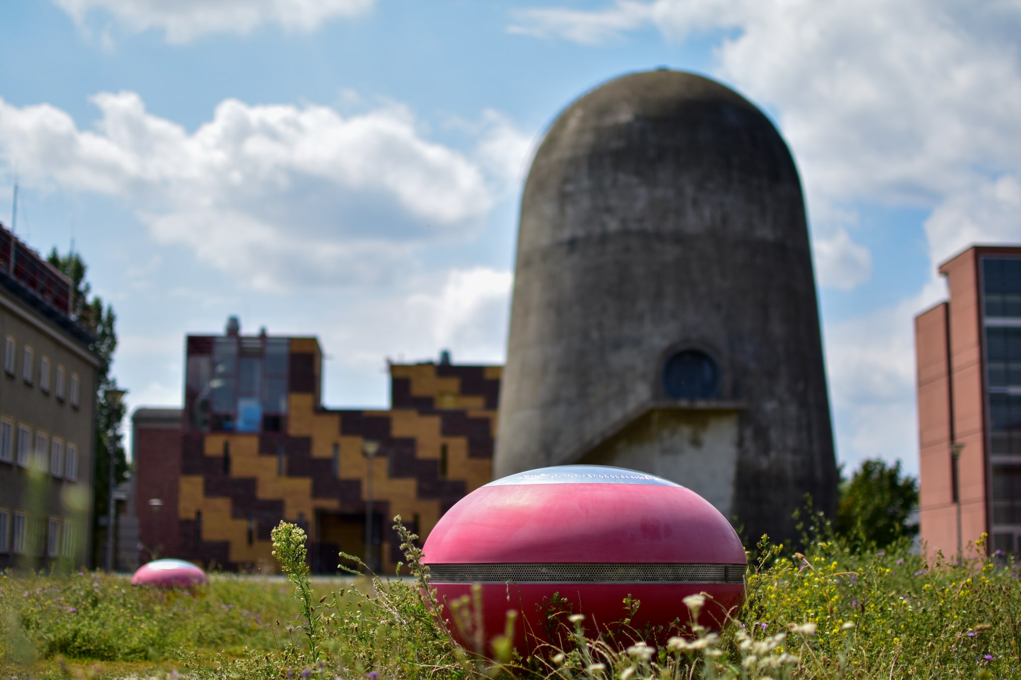 Spin tower, gray concrete tower, meadow, blue sky