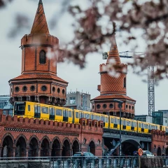 Oberbaumbrücke, Berlin, cherry blossoms, yellow subway crossing the Oberbaumbrücke, red clinker brick building