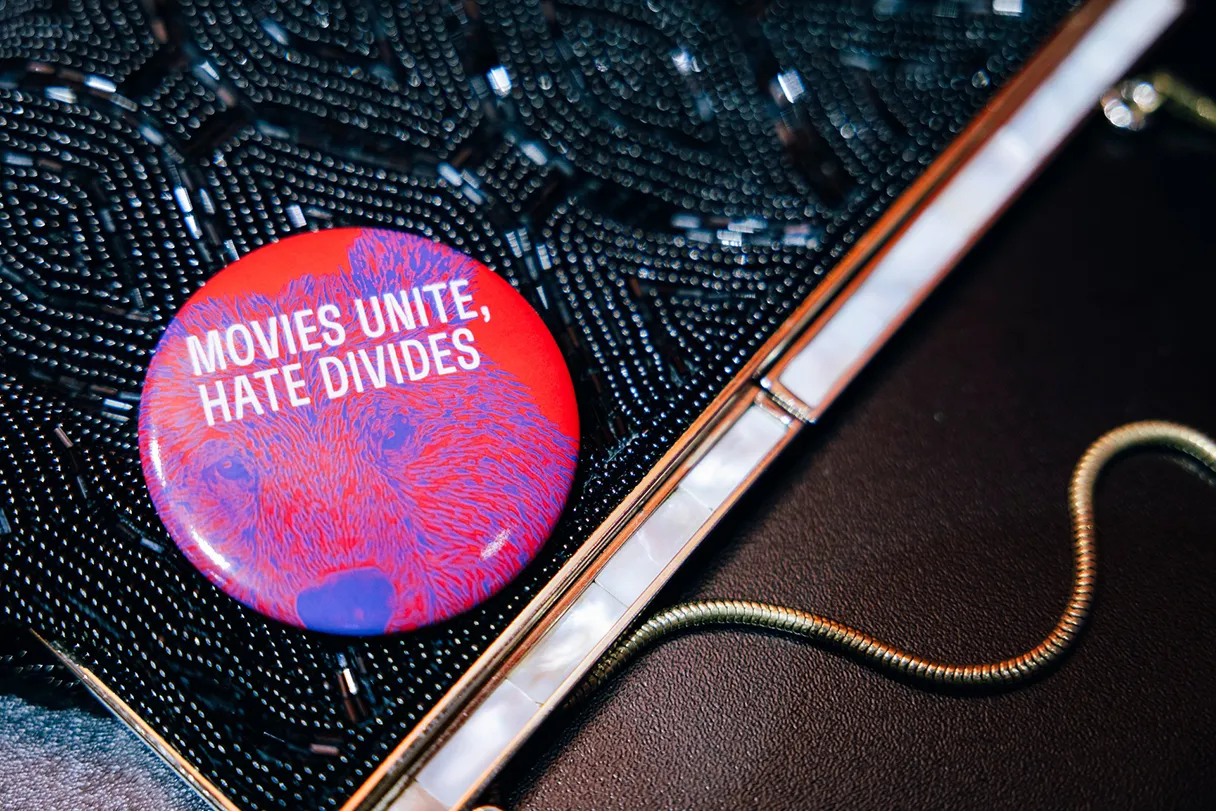 Berlinale button that reads “Movies unite, hate divides”. It's on a handbag.