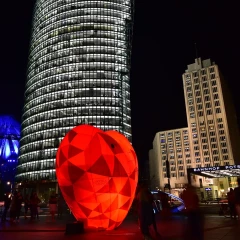 Festival of Lights Berlin, Potsdamer Platz, big red heart stands illuminated on Potsdamer Platz, in the background shine the Sony Center, DB Tower, Ritz Carlton Hotel