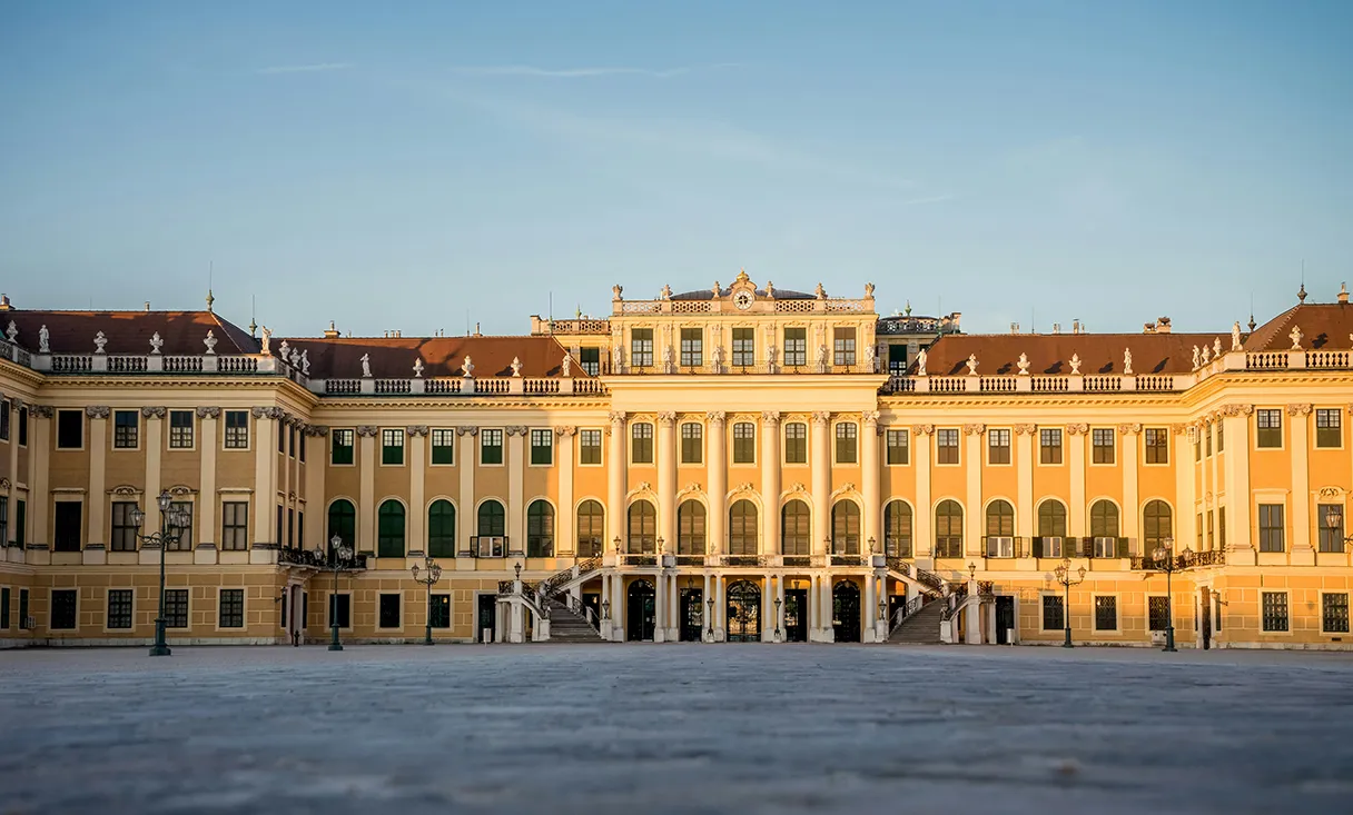 View of the yellow Schönbrunn Palace illuminated by the sun. Frog's-eye view.