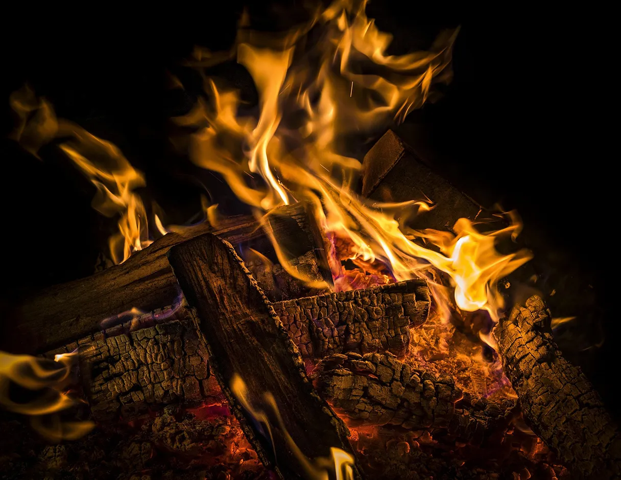 Easter bonfire. Wood is piled on top of each other and burns. Large flames blaze.