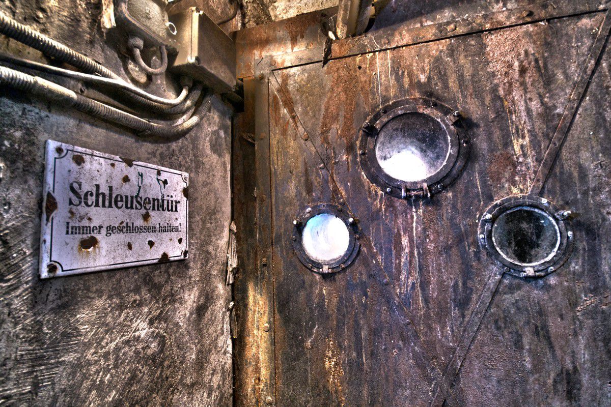 3rd man tour, sign on the left edge of the picture on which is written lock door, lock door with three portholes