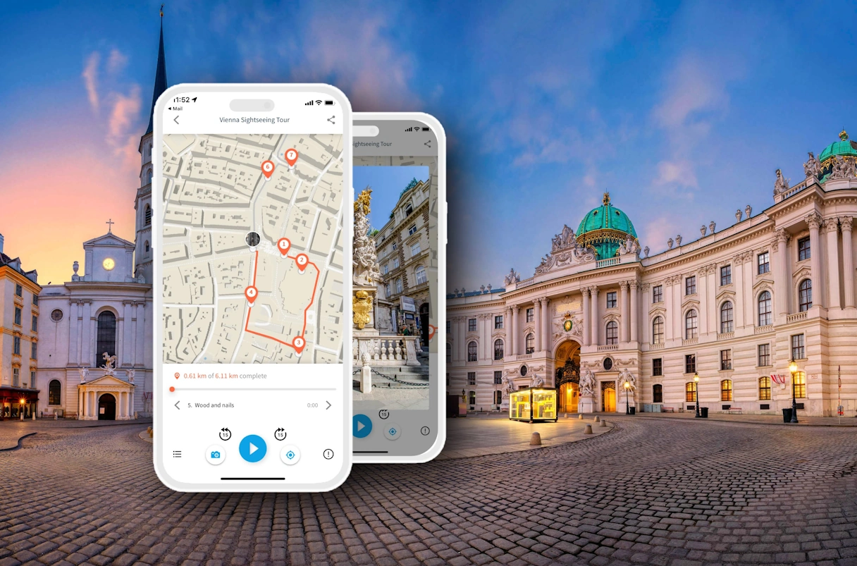 Stephansplatz Vienna at sunset. In the foreground is an artificially inserted cell phone with the TouringBee app open