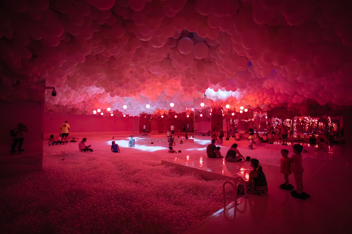 View of an exhibition room at the Balloon Museum in Barcelona. Red balloon pool. The whole ceiling is filled with balloons.