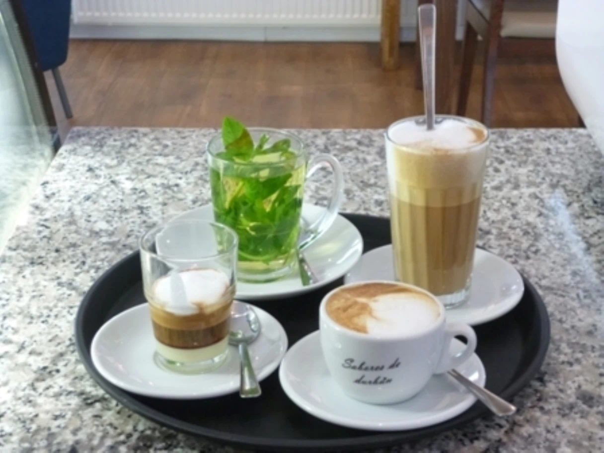 Café La Mouche, Tablett mit drei verschiedenen Kaffeesorten und einem frischen Glas Pfefferminztee