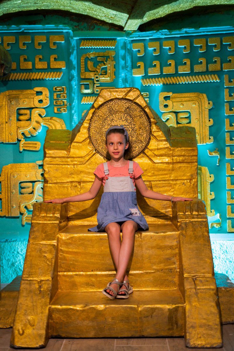 Chocolate Museum Vienna, girl sitting on a golden throne of the Aztecs