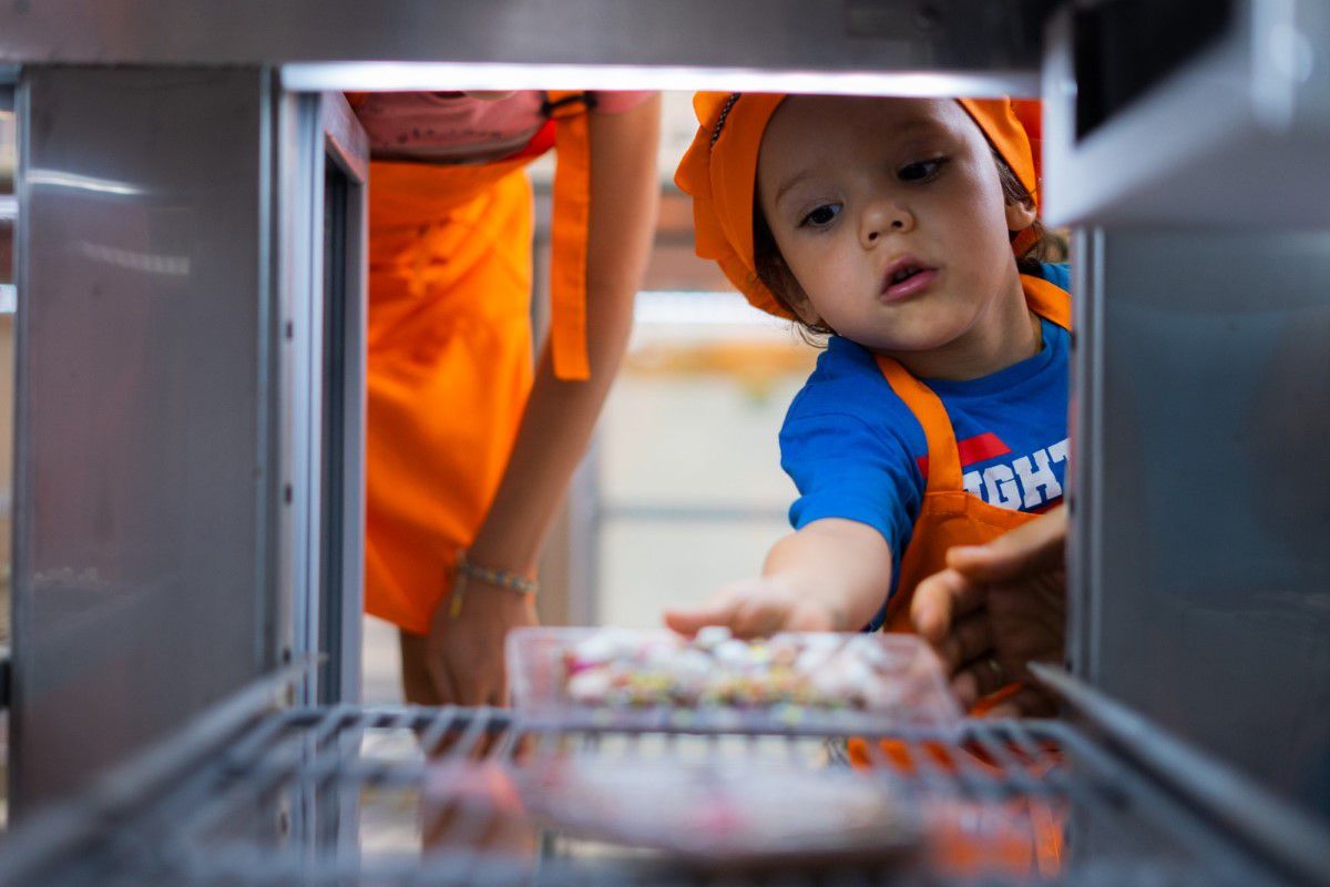 Chocolate Museum Vienna, little boy puts his self made chocolate in the fridge to chill