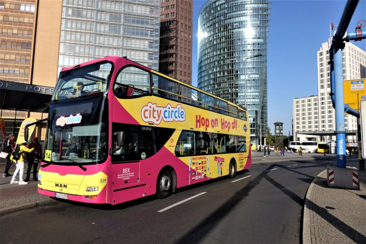 City Circle Sightseeing, Bus fährt am Potsdamer Platz am S-Bahnhof vorbei, sonniger Tag, blauer Himmel