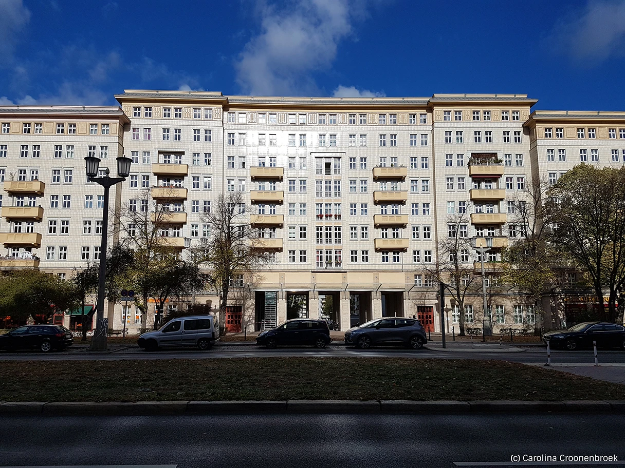 Karl-Marx-Allee, view on house, is illuminated by sun, blue sky