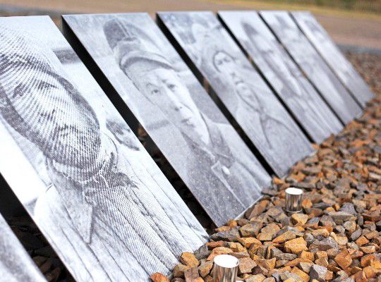 Sachsenhausen Concentration Camp, black and white pictures of inmates are lined up next to each other