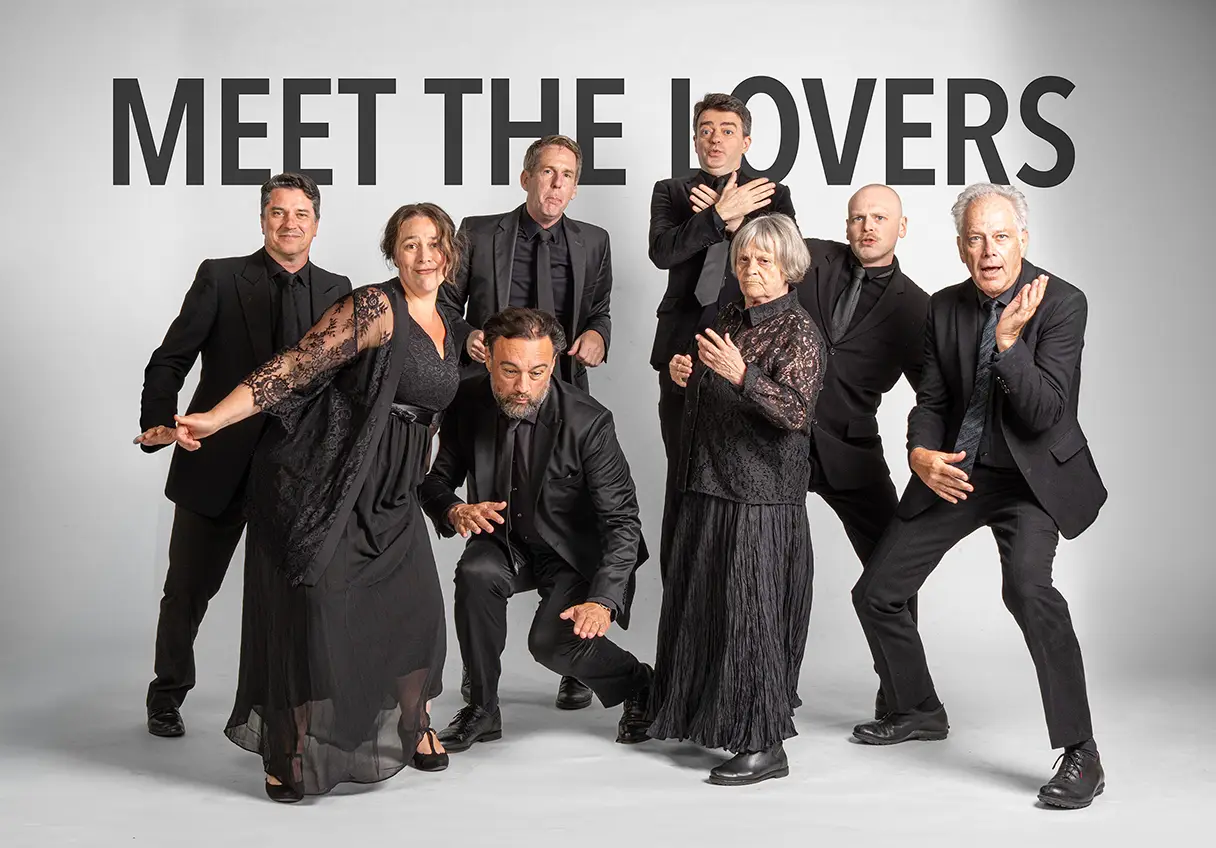 A group photo of various actors and actresses. Everyone is dressed in black. Each person is striking a different pose.