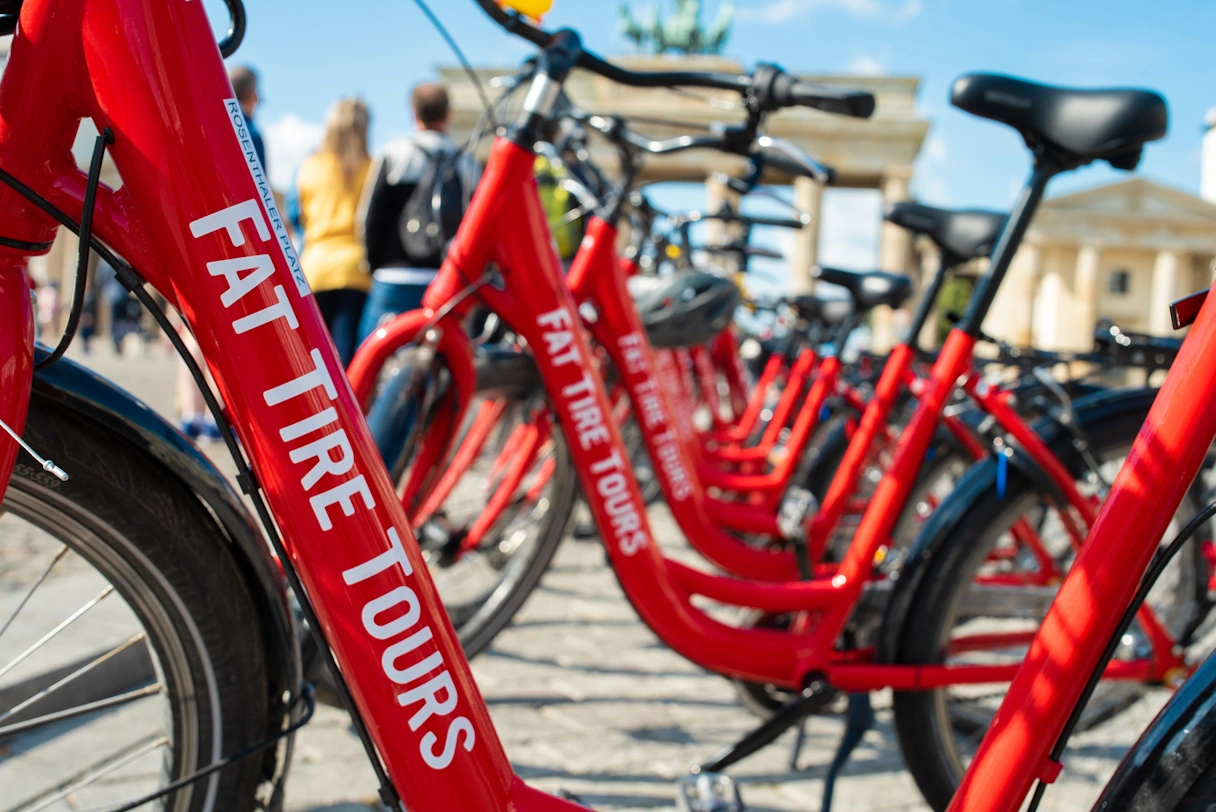 Red bicycles lined up at the Brandenburg Gate