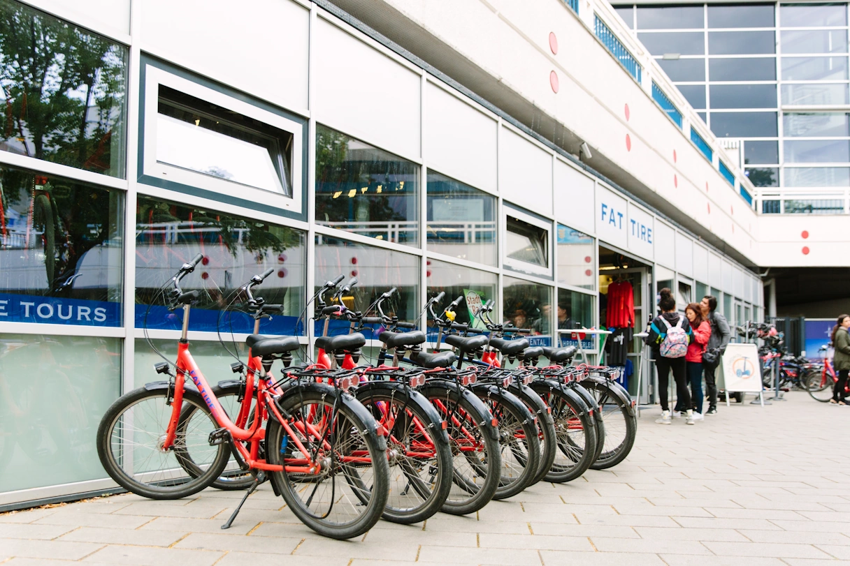 Red bikes lined up next to each other in front of the Fat Tire Tours store