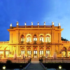 View of the illuminated Kursalon Hübner. Blue sky, no people, evening atmosphere.