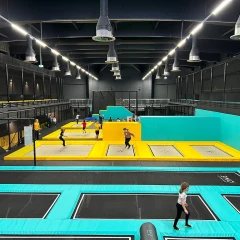 Jumpworld One, view into the trampoline hall, children jumping on the various trampolines